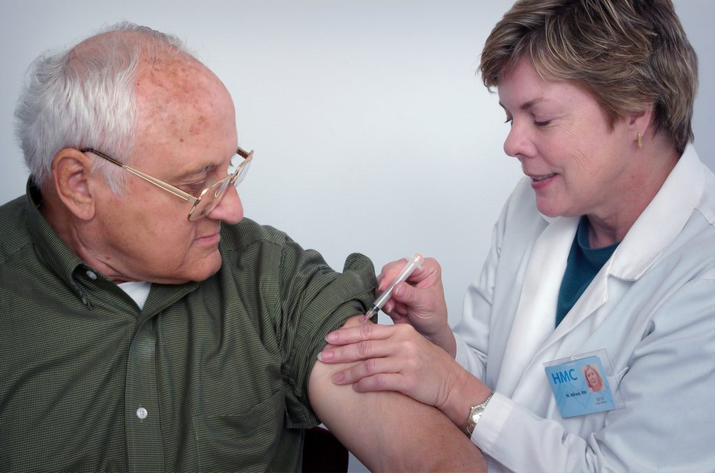 senior man getting vaccination