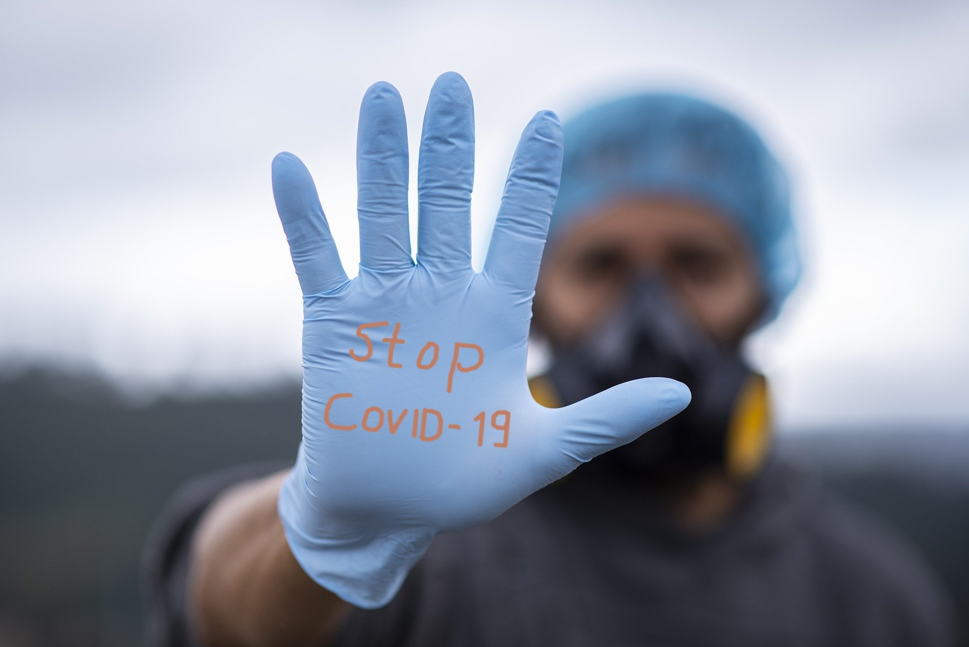 guy with hairnet, mask and glove "Stop Covid-19"