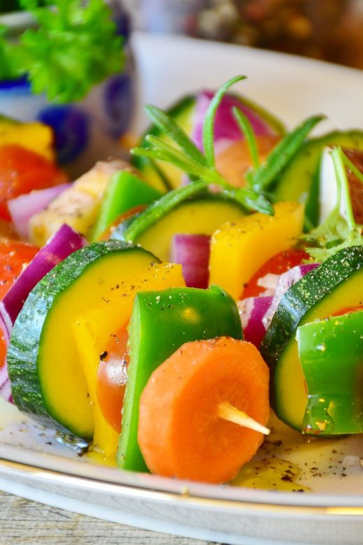 brightly-colored-vegetable-skewers-on-white-plate