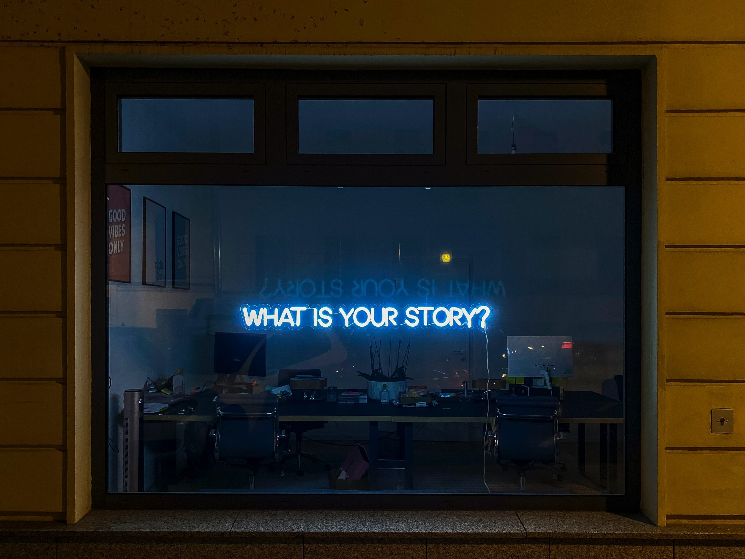 neon sign in window what is your story