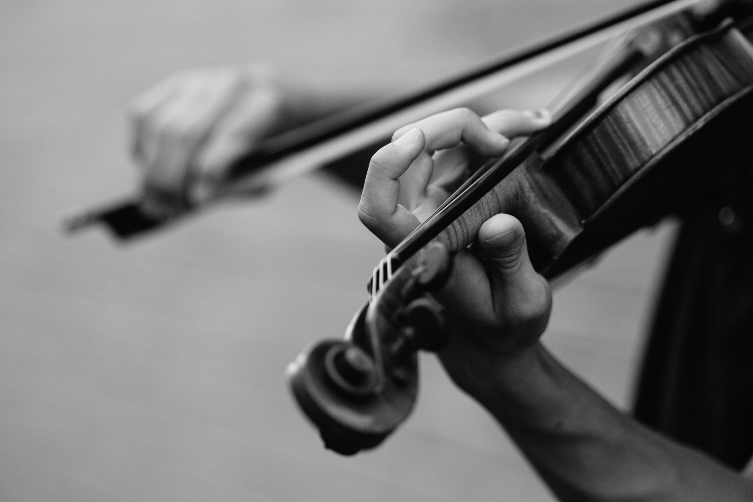 person playing violin by Joel Wyncott on Unsplash